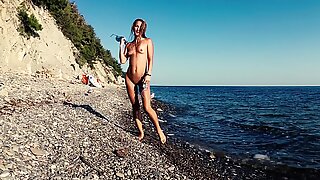 Travel slut teases a videographer and fucks him on the beach
